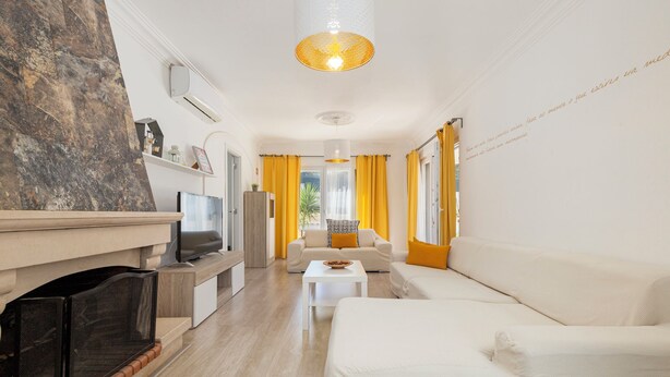 A modern living room with a fireplace, a sofa, a coffee table, and a television. - Lovely Farm with Pool @30min Lisbon and Beaches (Palmela)