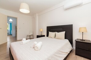 Relax in a spacious room with a large bed, bedside tables, and lamps.