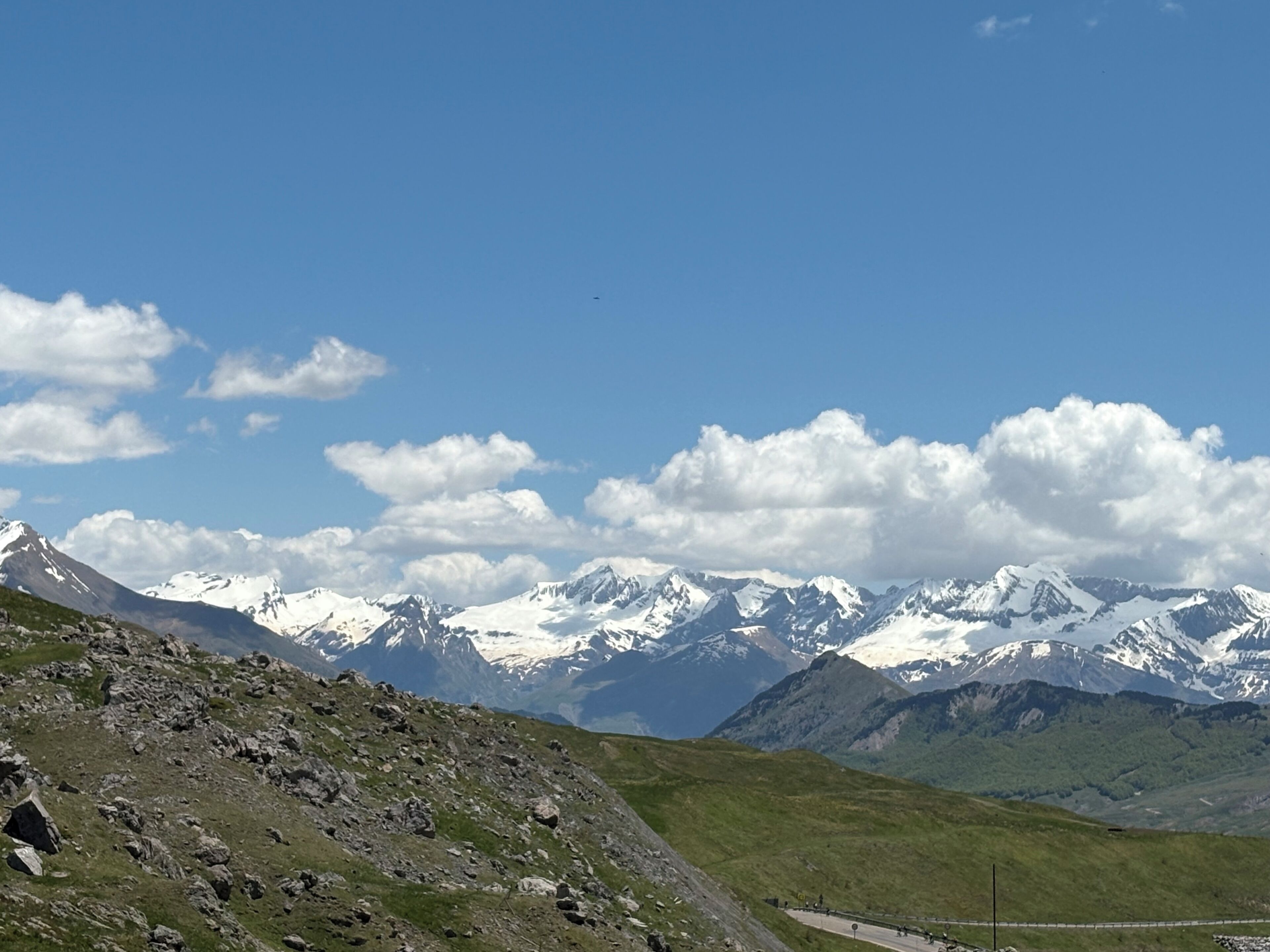 A mountainous landscape with snow-capped peaks and a clear sky.