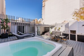 Enjoy a rooftop retreat with a pool, dining area, and comfortable seating.