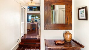 A wooden staircase leading to a second-floor area with a view of the outdoors. - 🏖️Oceanfront Kona Townhome w/ A/C | Walk to Magic Sands (Kailua Kona)