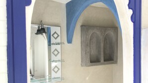 A bathroom with a white sink, a mirror, and a glass shelf. - A Great Value Doesn’t Last Long  (Marrakech)