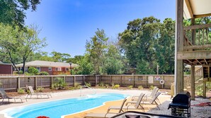 A backyard with a swimming pool, hot tub, and lounge chairs. - Sand Castle, 9 bedroom,6 1/2 bath,sleep 26,  pool, hottub, elevator, beach close (Oak Island)