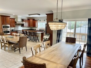 Enjoy meals and gatherings in this well-appointed kitchen and dining area, featuring a large island, sink, and comfortable seating.