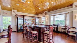 A restaurant with a wooden ceiling, a bar area, and a seating arrangement.
