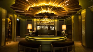A bar area with a unique ceiling design, a bar counter, and seating. - Chillax Heritage (Bangkok)