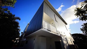 A modern building with a prominent triangular roof and a balcony. - Redhill Cairns Shared Living – Pembroke St (Parramatta Park)