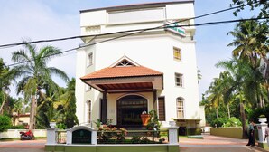 A two-story building with a red-tiled roof and a balcony. - V K G Group Holiday Hotel (Kochi)