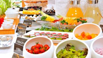 A buffet with various food items and a pitcher of orange juice.