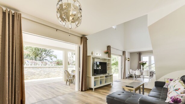 A spacious living room with a large TV, comfortable seating, and a view to an outdoor area. - Beautiful private villa for 8 guests with A/C, WIFI, private pool, TV and terrace (Cogolin)