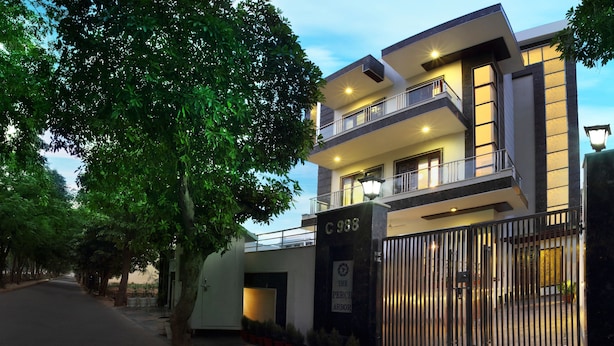 A modern multi-story building with a gated entrance, labeled "C 988". - Perch Arbor Suites (Gurugram)
