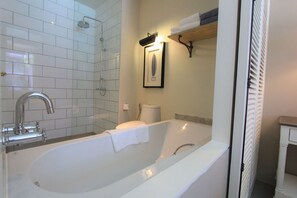 A bathroom with a bathtub, a shower, a toilet, and a towel rack. - Sugar Marina Resort  Surf  Kata (Karon)