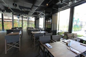 A restaurant with tables and chairs arranged for dining. - Sugar Marina Resort  Surf  Kata (Karon)
