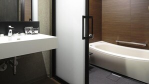 A modern bathroom with a white sink, a glass shower enclosure, and a wooden vanity. - Kyoyumean (Kyoto)