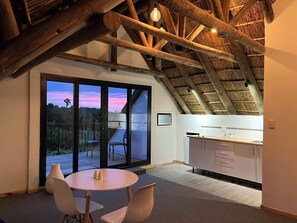 Superior Studio Suite | Living area | Flat-screen TV, Netflix, DVD player, iPod dock - Acara Guest Cottages (Stellenbosch)