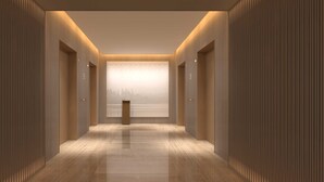A modern hallway with wooden paneling, a polished floor, and a view of a cityscape through a large window at the end. - Sincere Residence Changfeng (Shanghai)