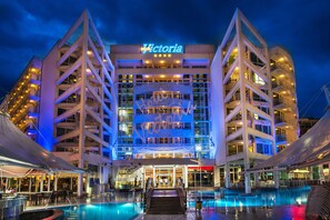 A multi-story hotel with a pool area in front, featuring a prominent 'Victoria' sign. - Effect Grand Victoria Hotel (Sunny Beach)