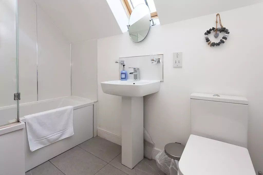 A bathroom with a bathtub, a sink, and a toilet.