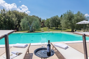 Una piscina al aire libre, sombrillas