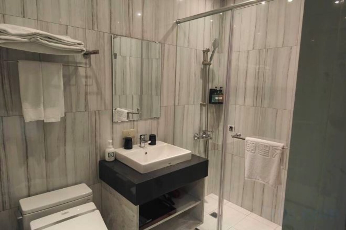 Bathroom | Shower, hair dryer, slippers, towels