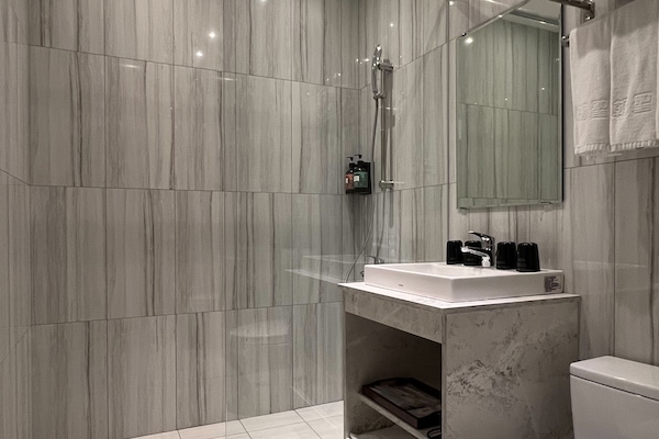 Shower, hair dryer, slippers, towels