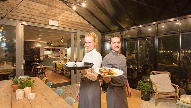 Un restaurant au décor intérieur en bois et doté de grandes fenêtres.