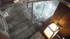 A stone staircase leading to a hot spring area with a wooden railing and a stone wall. - Hananoyado Fukuya (Hakone)