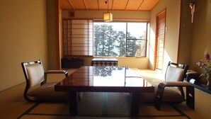A traditional Japanese room with tatami flooring, a low table, and shoji screens. - Hananoyado Fukuya (Hakone)