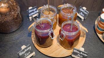 A display of various jams with labels indicating flavors like raspberry and apricot.