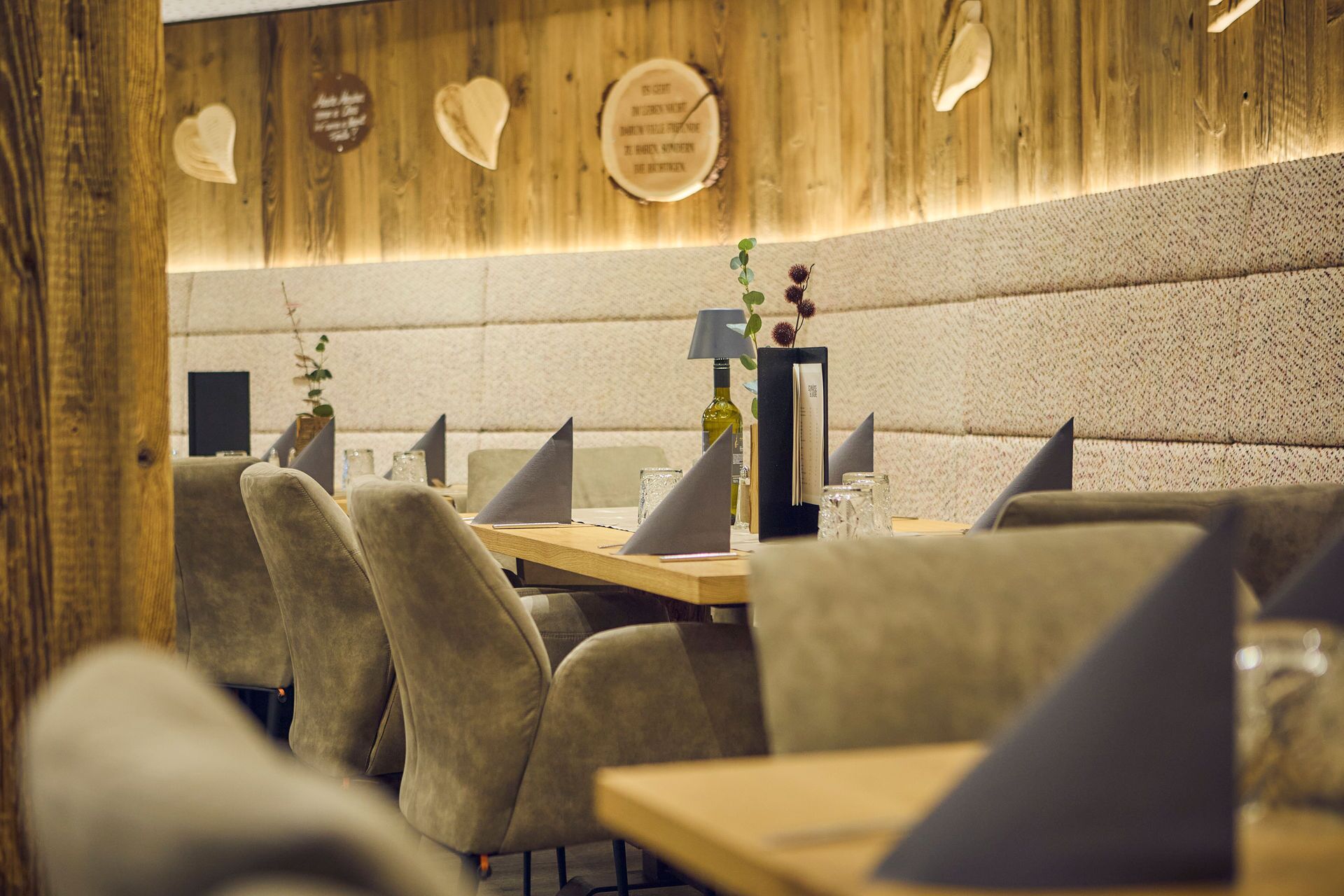 A restaurant with wooden walls, heart-shaped decorations, and a modern interior.