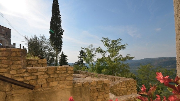 A stone structure with a view of a valley and distant hills. - Bella Vista Apartments (Motovun)