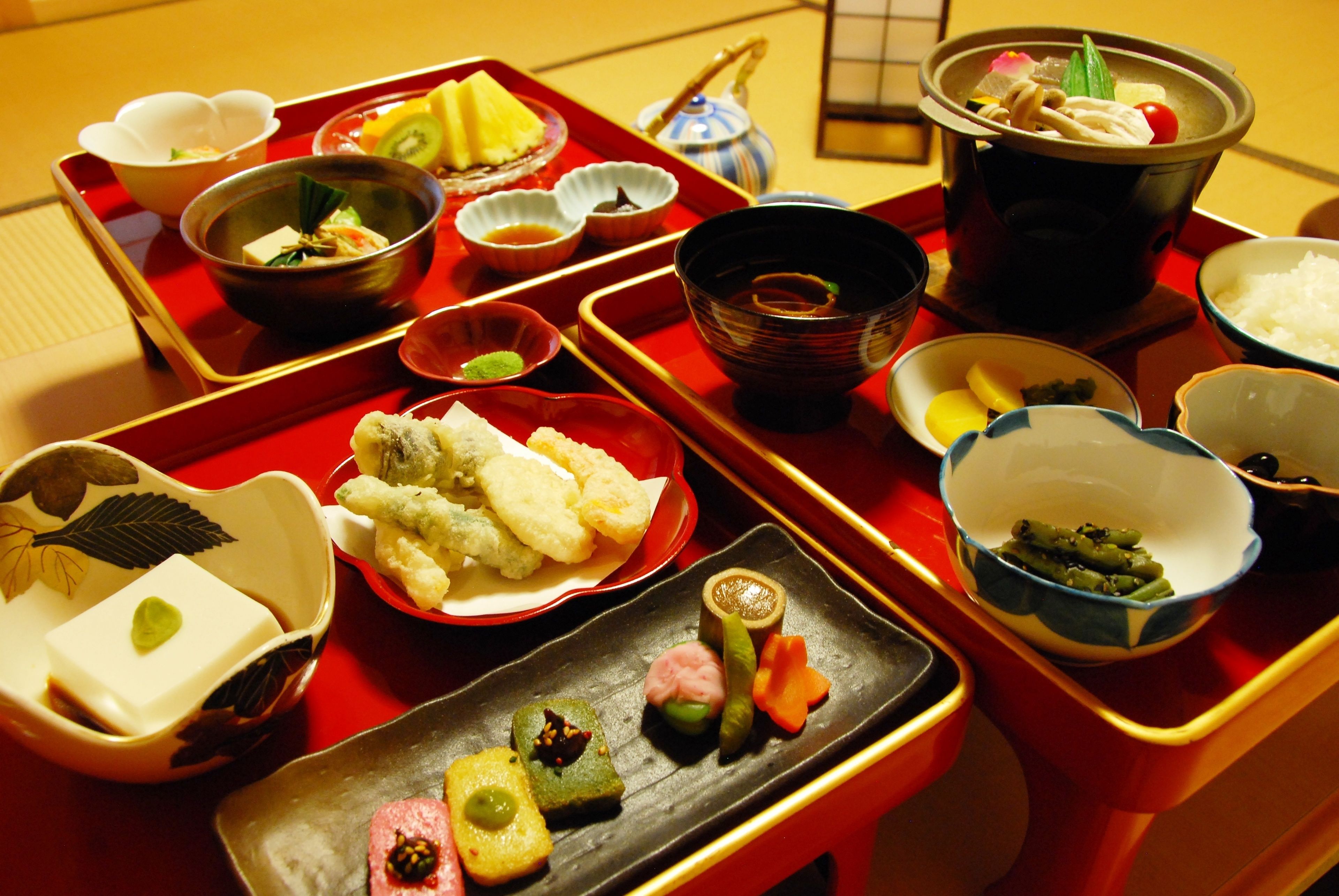 A traditional Japanese meal setup with various dishes and utensils on a tray.