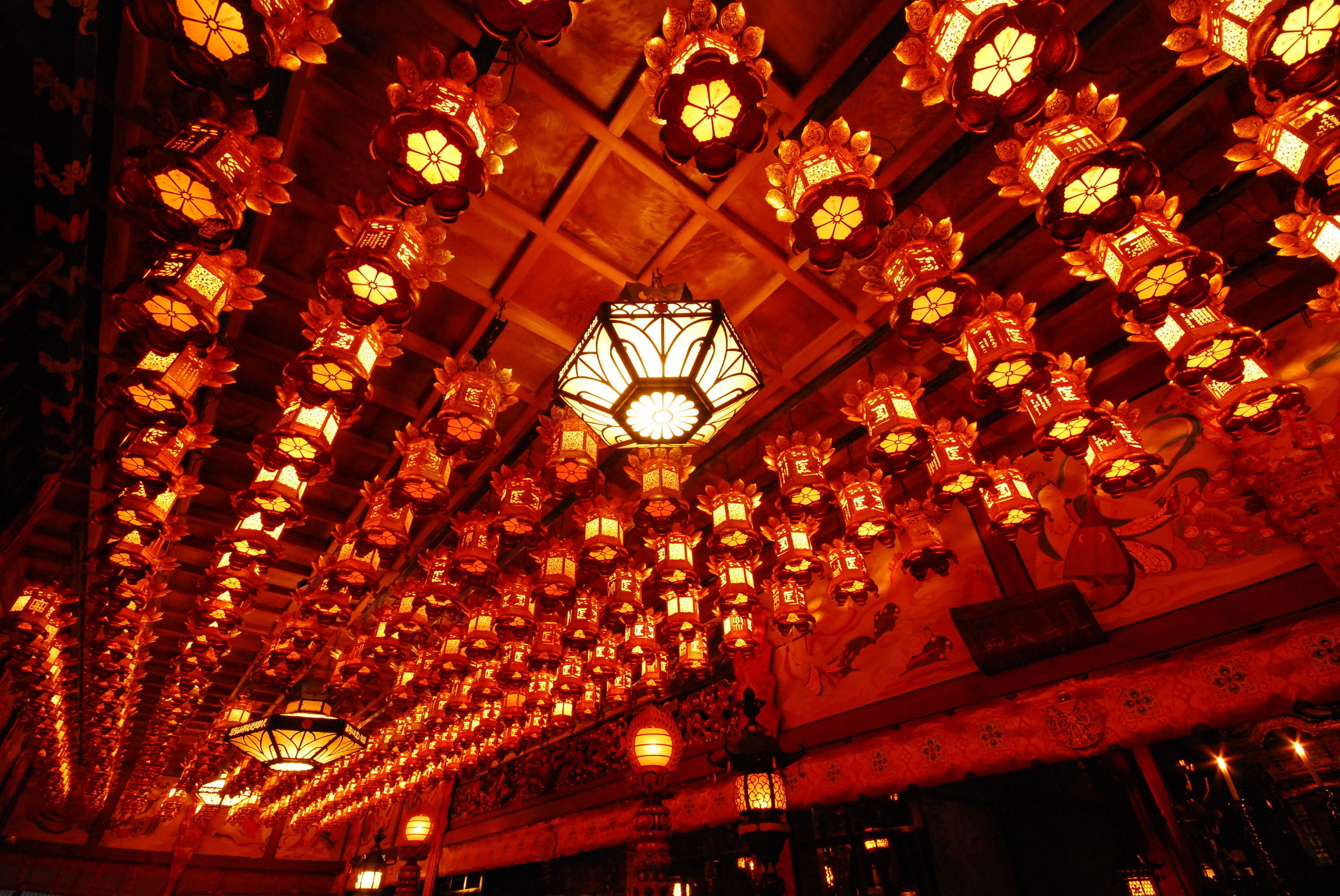 A ceiling with numerous traditional lanterns.