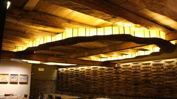 Ein Restaurant mit Holzbalkendecke und gedeckten Tischen.