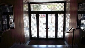 A hallway with a metal gate and a staircase leading to an upper floor. - Centro Storico B&B (Foggia)
