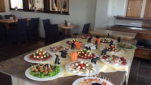 A buffet table with various food items and decorative elements. - Hotel Jägerhof (Schluchsee)