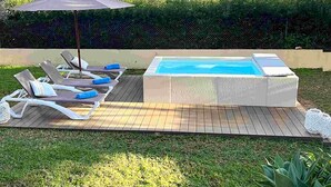 A hot tub with lounge chairs and an umbrella on a wooden deck. - Sa Copinya, Villa in front line of the beach, Mallorca (Son Servera)