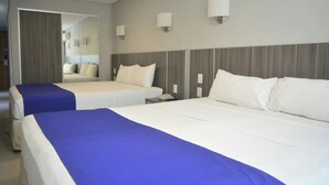 A hotel room with two beds, a mirror, and a nightstand with a phone. - City Falls Iguazú (Puerto Iguazú)