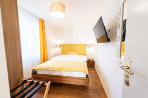 Family Room | Premium bedding, desk, blackout drapes, iron/ironing board