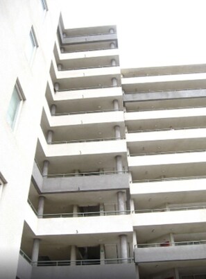 A multi-story building with a uniform architectural style, featuring balconies on each floor. - 4.- HNA Mirador El Faro (La Serena)