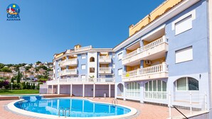 A hotel with a swimming pool, multiple balconies, and a view of the surrounding area. - Residencial Marcomar Casa Azahar (Alcala de Xivert)