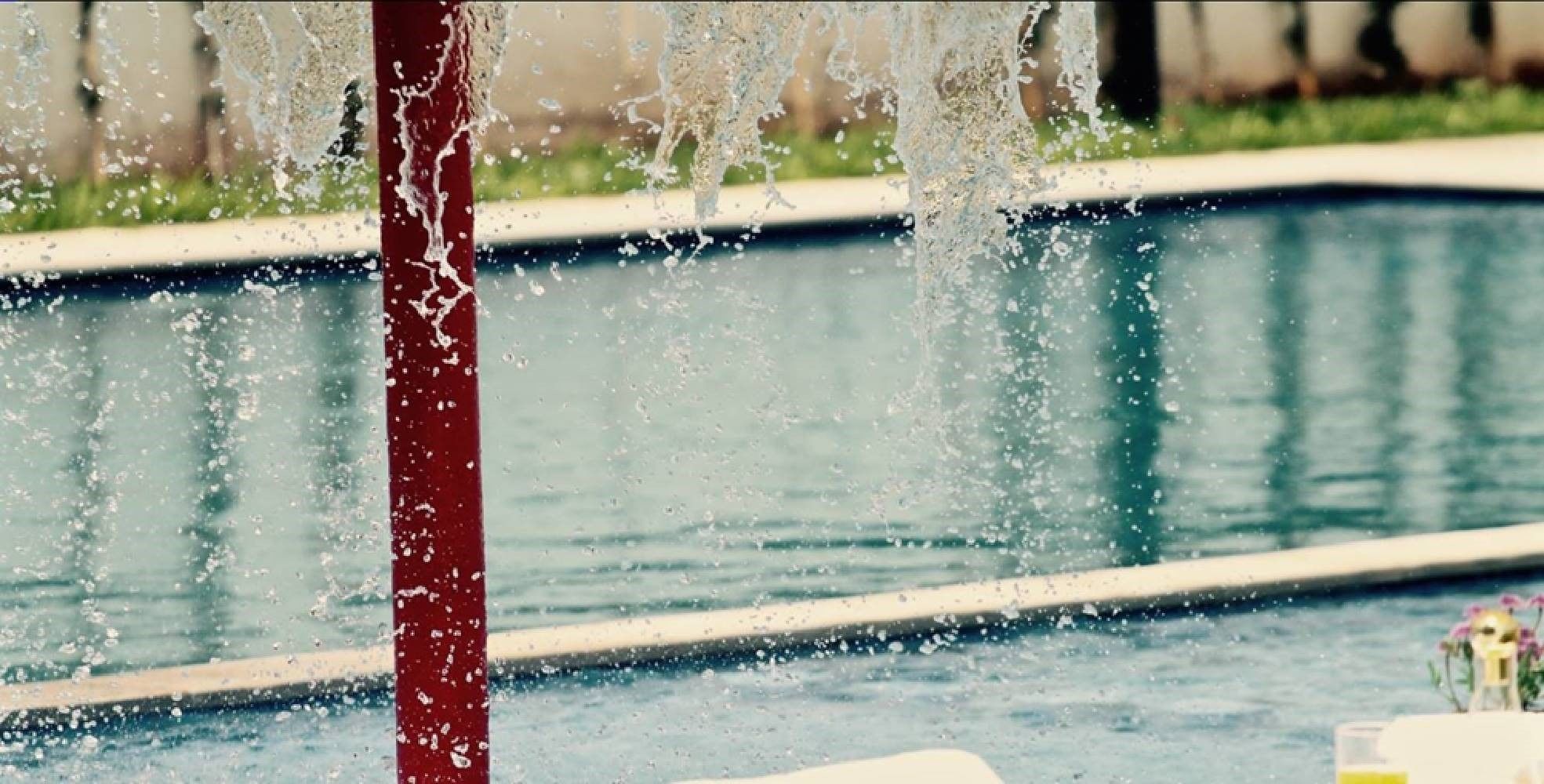 A pool with water jets spraying upwards.
