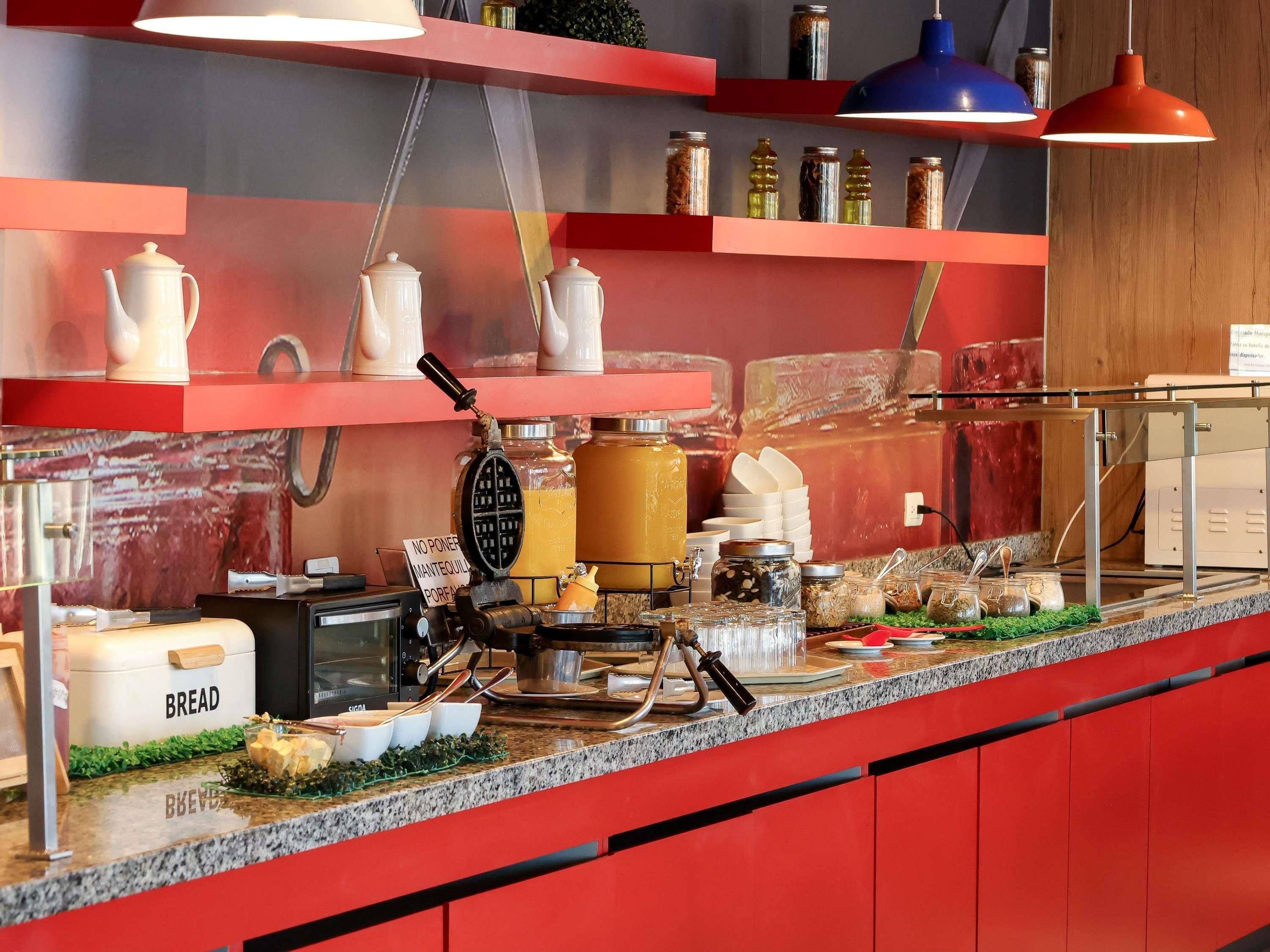 A kitchen counter with various food items and kitchen equipment.