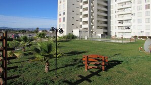 A multi-story residential building with balconies and a grassy courtyard. - 36.- HNA Paseo Peñuelas (La Serena)