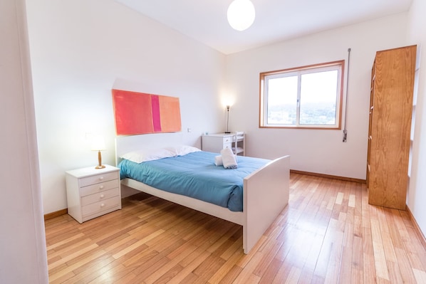Enjoy a peaceful retreat with a neatly made bed and city views from the large window.