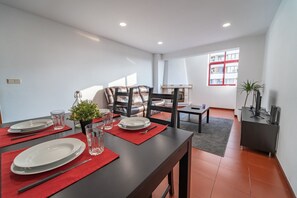 Enjoy a meal for two at a beautifully set table, surrounded by a cozy seating area and natural light.