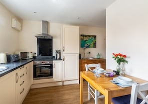 Enjoy cooking and dining in this well-equipped kitchen with oven, microwave, and stovetop.