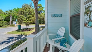 A porch with two Adirondack chairs, a small tree, and a sign that reads "Welcome to the Beach." - Blue Mountain Beach, Sleeps 12, Steps from Pool + Free Attraction Tickets! (Santa Rosa Beach)