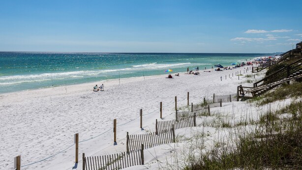 A beach with a wooden fence, sandy shore, and ocean view. - Blue Mountain Beach, Sleeps 12, Steps from Pool + Free Attraction Tickets! (Santa Rosa Beach)