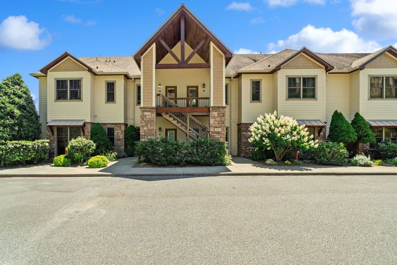 A two-story building with a central entrance, a staircase, and a balcony.